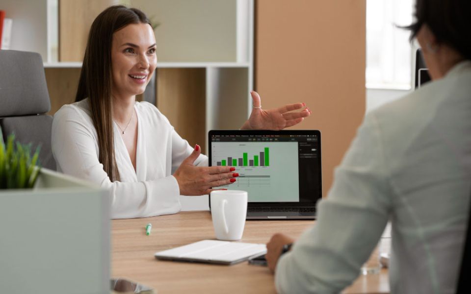 woman shows growth stats on laptop